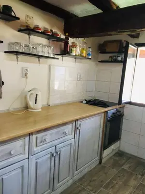 a kitchen with a wooden counter top in a room at СЪНТОВЕЦ - на брега на язовир Цонево in Tschenge