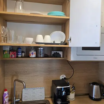 a kitchen counter with a sink and a microwave at Aпартамент 5 in Varna City
