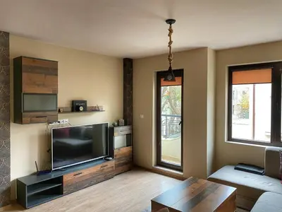 a living room with a large flat screen tv at Stylish URBAN Apart New 2021 Close to the Beach in Varna City