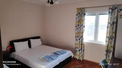 a small bedroom with a bed and a window at UNIQUE LOCATION APARTMENT WITH PARKING in Burgas City