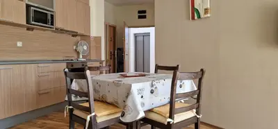 a kitchen with a table and chairs in a room at CarolMike Oasis Beach Apartment Kamchia Reserve in Kamchia