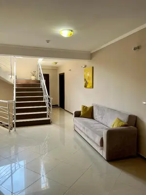 a living room with a couch and a staircase at Villa Orange in Sozopol