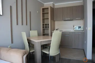 a kitchen with a wooden table and chairs at Villa Orange in Sozopol