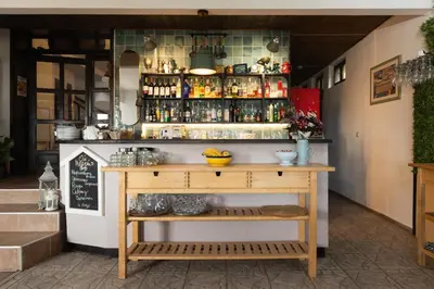 a restaurant with a counter with a shelf at VILLA SOL in Sunny Beach