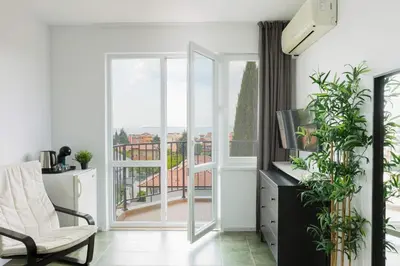 a living room with a view of a balcony at VILLA SOL in Sunny Beach
