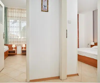 a white room with a bed and a mirror at BulgariaVilla - Villa Amber in Bryastovets