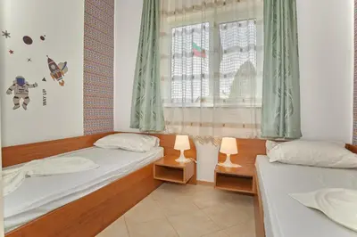 two beds in a room with a window at BulgariaVilla - Villa Amber in Bryastovets
