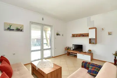 a living room with a couch and a tv at BulgariaVilla - Villa Amber in Bryastovets