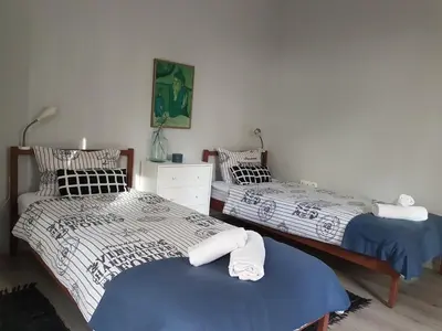 two beds sitting next to each other in a bedroom at Flat in Varna, central location, close to beach in Varna City