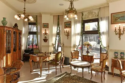 a living room with a table and chairs at Royal Hotel in Varna City