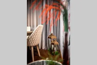a room with a chair and a table and a curtain at A&K COZY ART Studio 1 in Varna City