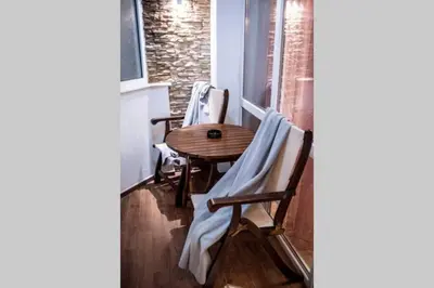 a table and chairs sitting on a balcony at A&K COZY ART Studio 1 in Varna City