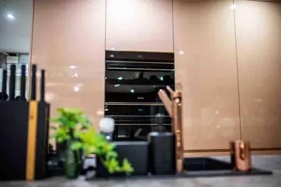 a person sitting in front of an oven in a kitchen at A&K COZY ART Studio 1 in Varna City