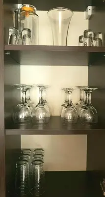a shelf with glass jars and vases on it at Obzor Beach Resort Apartment G-109 in Obzor