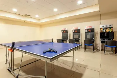 a ping pong table in a room with chairs at Obzor Beach Resort Apartment G-109 in Obzor