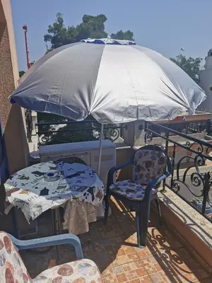 a table and chairs and an umbrella on a balcony at villa Bonita in Sunny Beach