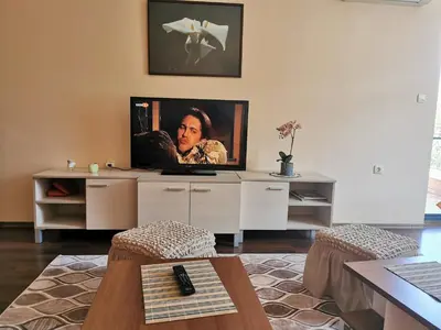 a living room with a flat screen tv on the wall at villa Bonita in Sunny Beach