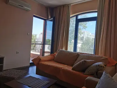 a living room with a couch and a large window at villa Bonita in Sunny Beach