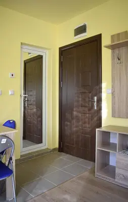 a room with two wooden doors in a room at Starlight Studios in Burgas City