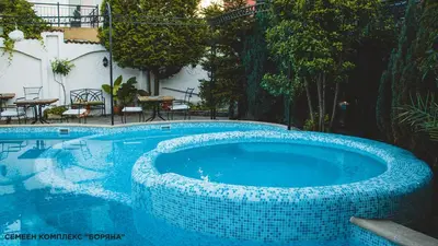 a large swimming pool with a blue tiled swimming poolvisor at Boryana Hotel in Burgas City