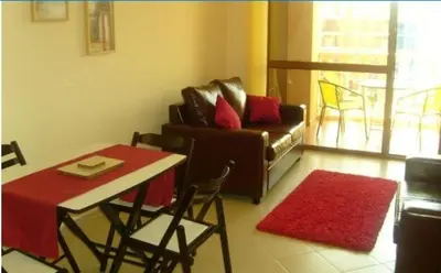 a living room with a couch and a table and chairs at Kalia Apartment Sunny Beach 2-Zimmer+Balkon TOP in Sunny Beach