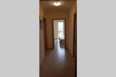 a hallway with a door leading into a room at Kalia Apartment Sunny Beach 2-Zimmer+Balkon TOP in Sunny Beach