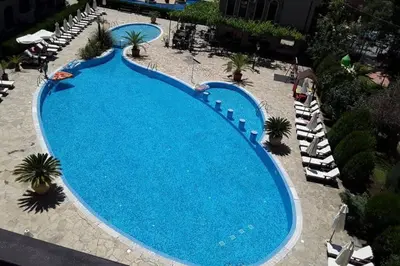 an overhead view of a large swimming pool with chairs at Kalia Apartment Sunny Beach 2-Zimmer+Balkon TOP in Sunny Beach