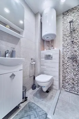 a bathroom with a toilet and a sink and a shower at Апартамент S Apart in Varna City