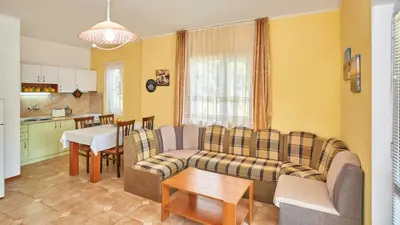 a living room with a couch and a table at BulgariaVilla - Green Life Villas in Bryastovets