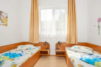 two beds in a room with a window at BulgariaVilla - Green Life Villas in Bryastovets