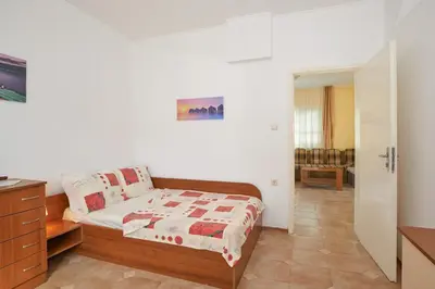 a bedroom with a bed and a dresser in it at BulgariaVilla - Green Life Villas in Bryastovets