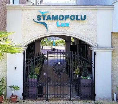 a gate in front of a store with a sign on it at Sea View Apartment free parking in Primorsko