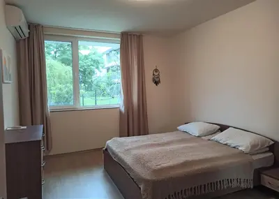 a bedroom with a bed and a large window at Apartment Relax Lozenets in Lozenets