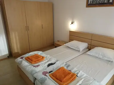 a bedroom with two beds with orange towels on them at Cozy family villa 500m. from the beach in Byala