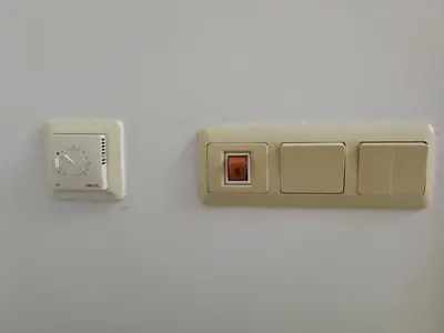 a white outlet on a wall with a switch at Cozy family villa 500m. from the beach in Byala