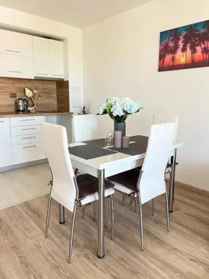 a dining room table and chairs in a kitchen at Summer Apart Janet in Obzor