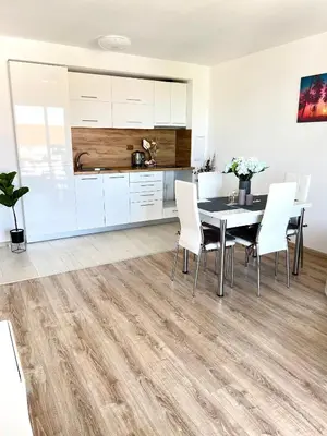 a kitchen and dining room with a table and chairs at Summer Apart Janet in Obzor