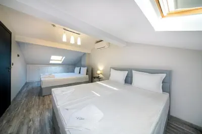 a bedroom with a large white bed in a room at Boutique Guest House