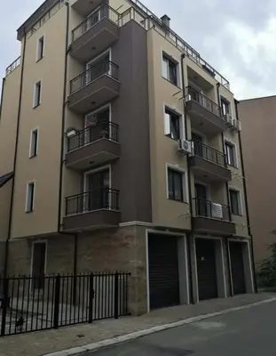 a tall building with balconies on the side of it at Studio Emi in Pomorie