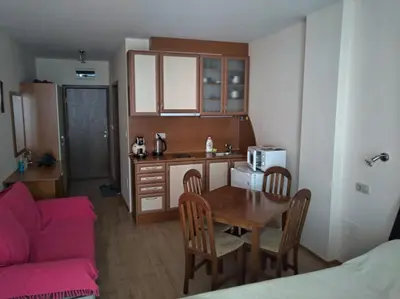 a small kitchen with a table and a couch at ЛЕСО-Зара студио in Ravda