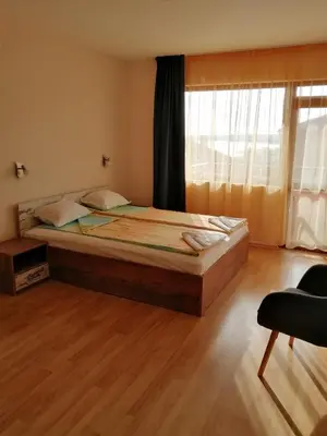 a bedroom with a large bed in a room at Дом Апостолови in Sozopol