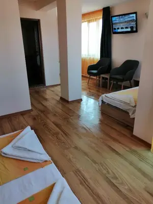 a room with two beds and a wooden floor at Дом Апостолови in Sozopol