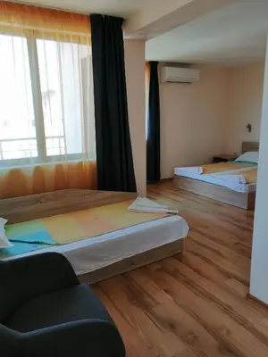 a room with two beds and a couch in it at Дом Апостолови in Sozopol