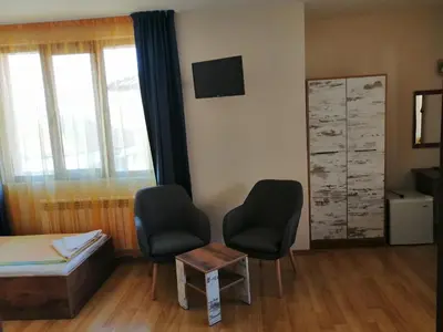 a room with two chairs and a bed and a table at Дом Апостолови in Sozopol