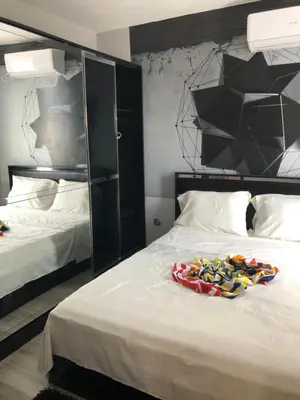 a bedroom with a bed with shoes on it at ELIT 2 APART HOTEL in Sunny Beach