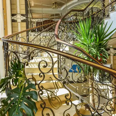a metal spiral staircase with plants on it at FLORENCE SUITES APART HOTEL in Sveti Vlas
