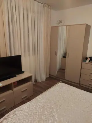 a bedroom with a bed and a television on a dresser at Byala COZY APARTMENT in Byala
