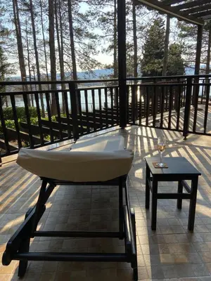 a bath tub sitting on a deck with a table at Tiny Bijou Sea View studio - Santa Marina - Sozopol in Sozopol