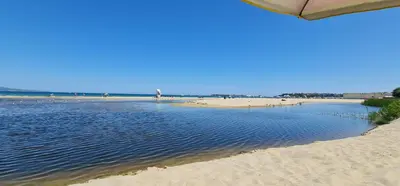 a beach with sand and the ocean in the background at Dimi's River Park in Sunny Beach