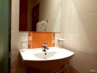 a bathroom with a white sink and a mirror at Dimi's River Park in Sunny Beach